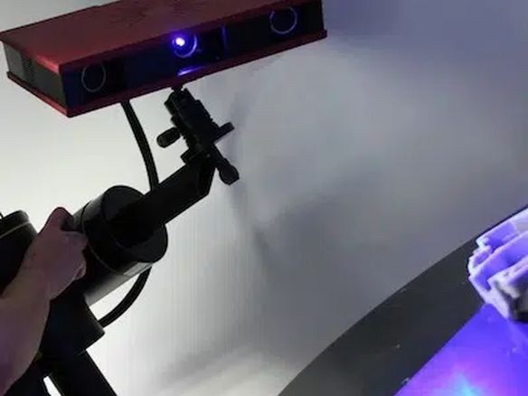 Structured-light 3D scanner capturing a part